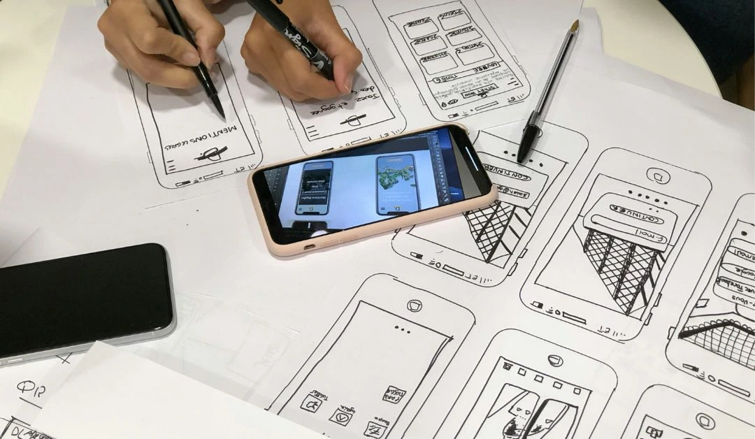 Web developer in Nashville testing a responsive website across a laptop, tablet, and mobile phone using AI tools.