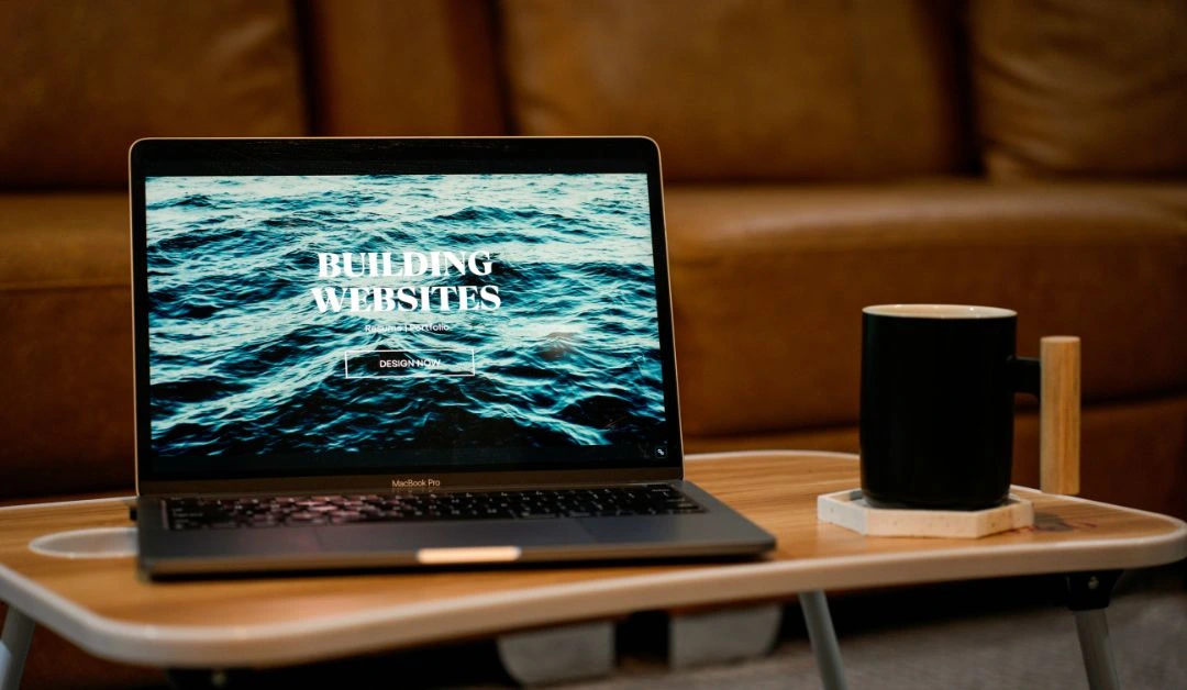 Open laptop on a wooden table in a cozy workspace, evoking the energy of Cincinnati’s growing tech and creative scene.