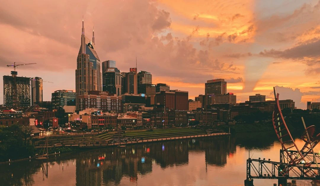 Aerial view of downtown Nashville at sunset with modern buildings and vibrant lighting, representing the city’s growing tech scene.