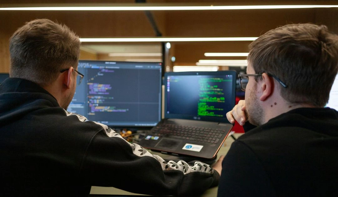 Web developers in a Nashville studio using collaborative tools and AI dashboards to streamline a website project.