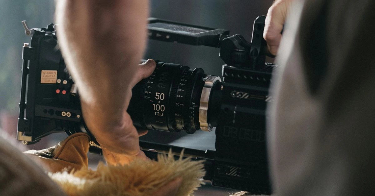 A videographer holding camera