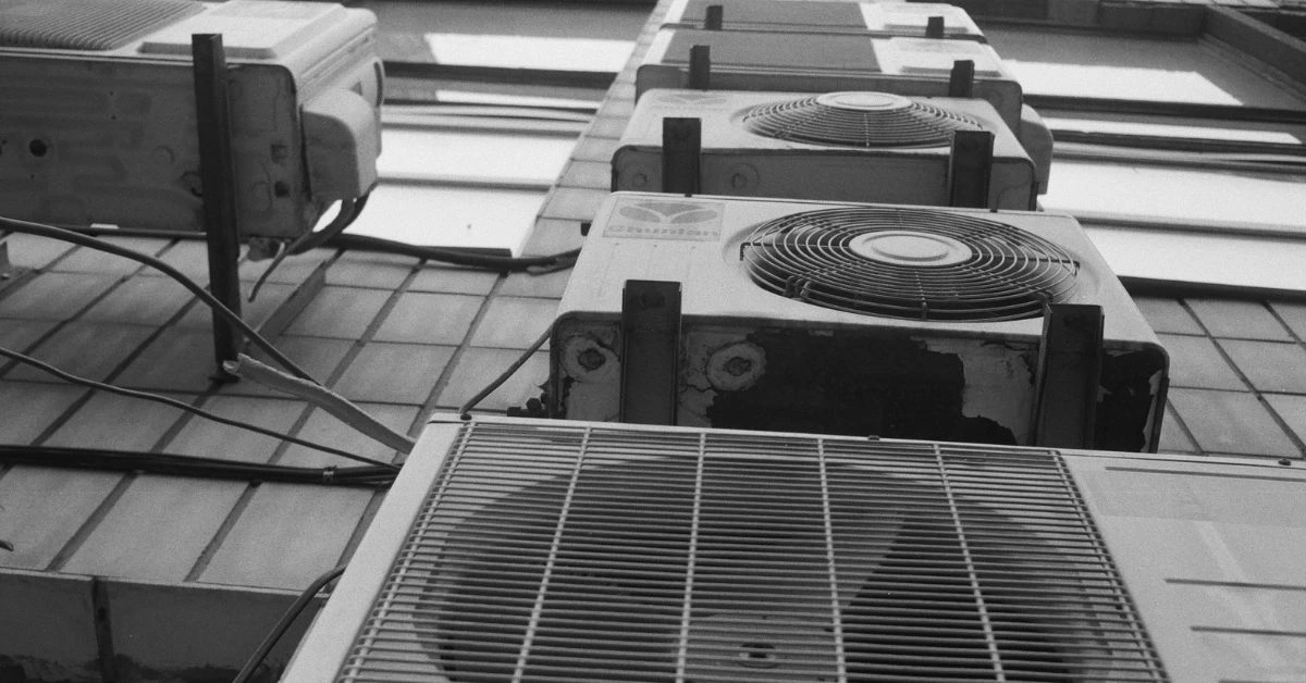 Black and white photo of multiple air conditioning units mounted on the exterior wall of a building in Nashville.