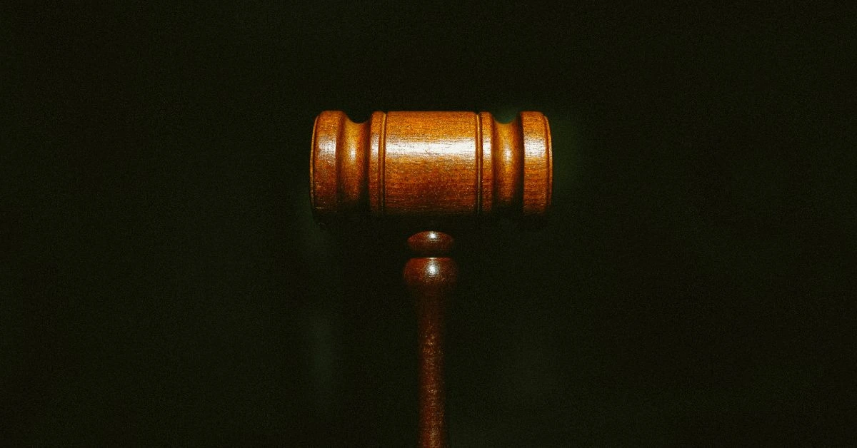 Close-up of a wooden judge’s gavel against a dark background, symbolizing justice in Nashville.