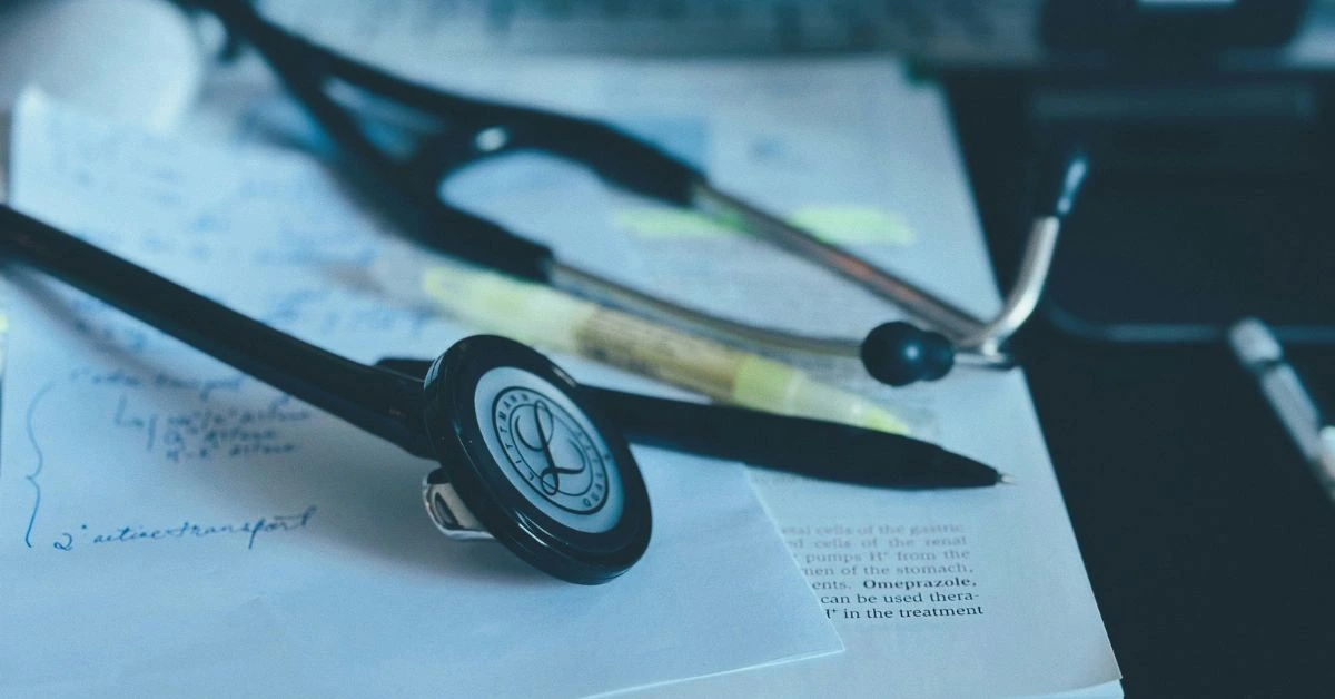 Close-up of a stethoscope, highlighter, and medical notes on a desk in a Nashville healthcare setting.